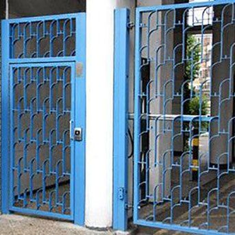 STEEL GATES ENTRY SYSTEM Blue security gates with intricate design, showcasing access control features, suitable for communal and residential security installations.