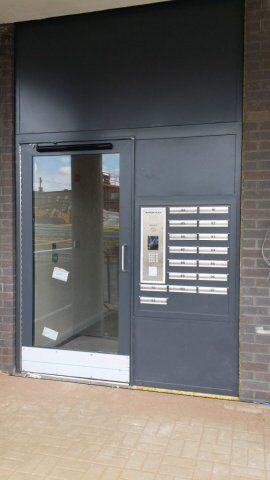 Secure by Design accredited communal door with integrated mailbox system, showcasing high-security features and modern design, relevant to Premier Security's product range.