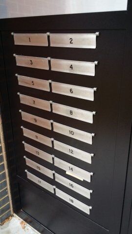 Secure by Design accredited mailbox unit featuring numbered slots for residential and commercial use, emphasizing high security standards and durability.