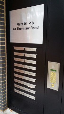 Secure entry system with intercom and mailboxes for Flats 01-18 at 4a Thornlaw Road, emphasizing safety and access control features relevant to Secure by Design standards.