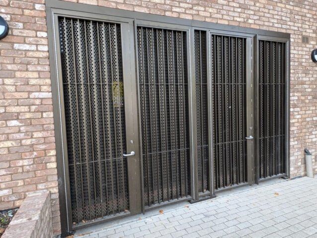 Secure by Design accredited steel doors with perforated metal grilles, showcasing enhanced security features for residential and commercial properties.