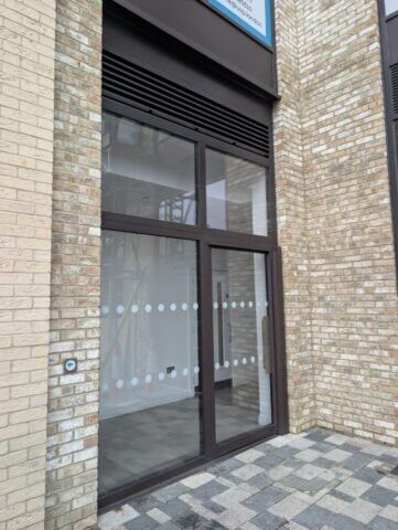 Secure by Design accredited communal steel door installation with louvre features, set in a brick exterior, showcasing durability and modern design for enhanced security.