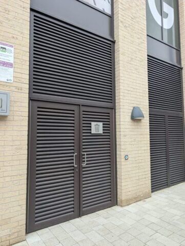 Secure by Design accredited communal steel doors with louvre design, featuring a modern aesthetic and durable construction, enhancing building security.