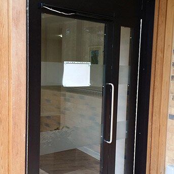 Secure by Design accredited glass door with black frame, featuring a sleek handle and transparent panels, suitable for enhancing security in residential and commercial properties.