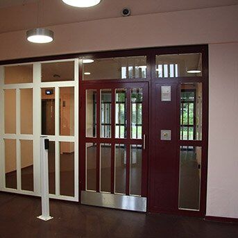 Secure by Design certified communal security doors with glass panels, showcasing durability and modern design in a commercial setting.