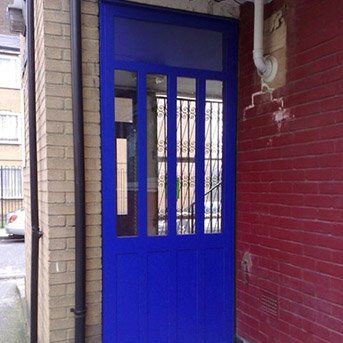 Secure by Design accredited blue security door with glass panels, enhancing safety and aesthetic appeal in residential settings.
