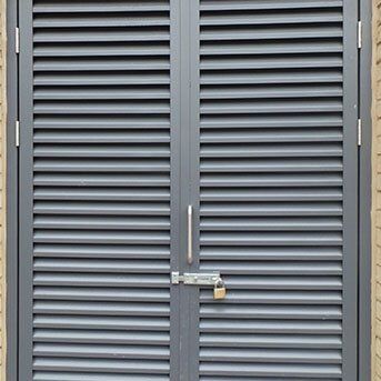 Louvre security door with padlock, emphasizing durability and safety, featured in Premier Security's Secure by Design product range.