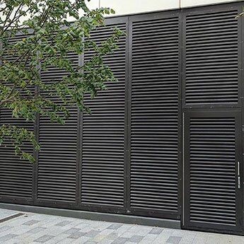 Louvre security doors in a modern architectural setting, showcasing durability and design compatibility for enhanced safety in residential and commercial properties.