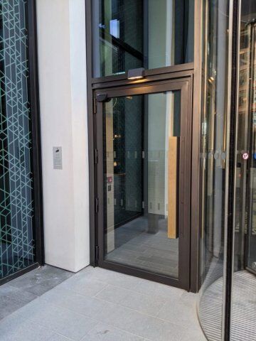 Secure by Design accredited security door with glass panels and metal frame, positioned at an entrance, showcasing modern design and durability for enhanced safety in residential and commercial properties.