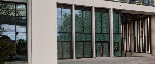 Curtain walling installation featuring secure glass panels and modern architectural design, enhancing safety for commercial properties.